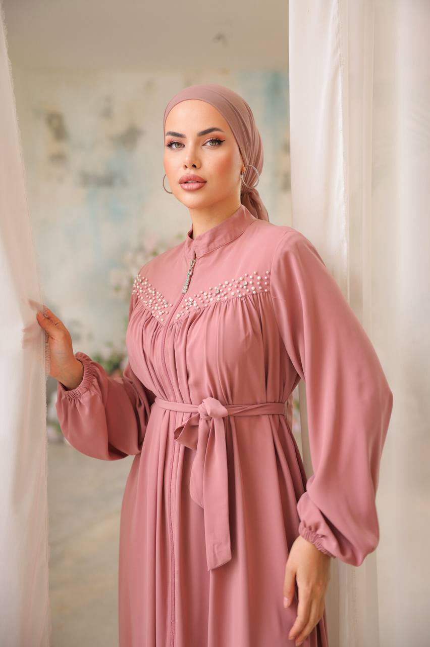 Model wearing a Rose pink front zipper abaya embellish with pearls