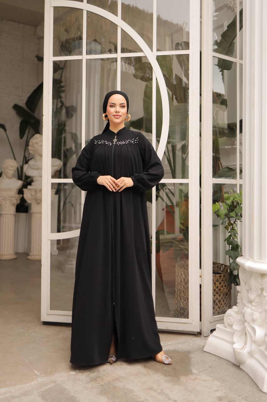 Elegant black abaya front zipper closure, adorned with delicate pearls on the upper front for a sophisticated look.
