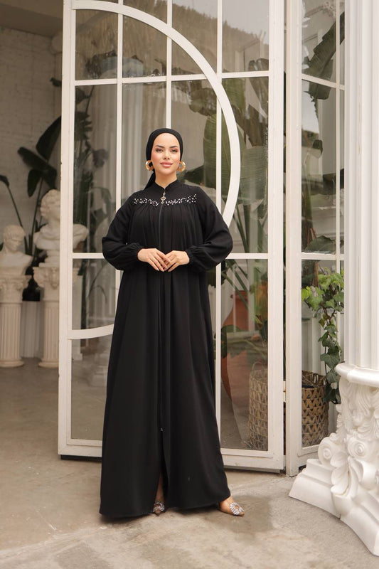 Elegant black abaya front zipper closure, adorned with delicate pearls on the upper front for a sophisticated look.