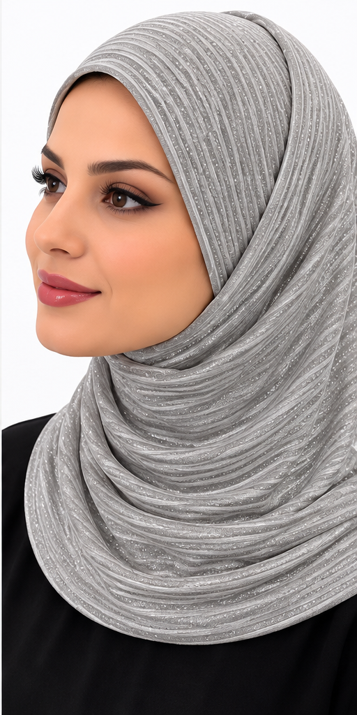 **Silver Grey:** Woman wearing a silver grey 2\-piece slip\-on hijab with sparkling striped detailing, styled with a black outfit\.