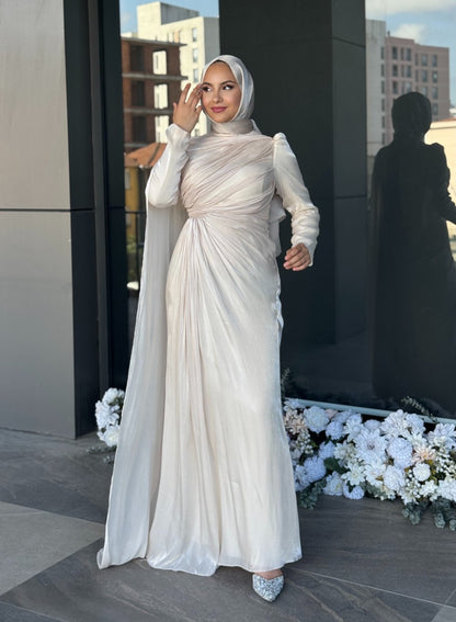 Graceful champagne modest dress featuring diagonal pleats, floor-length flow, and a matching hijab — ideal for engagement or reception events