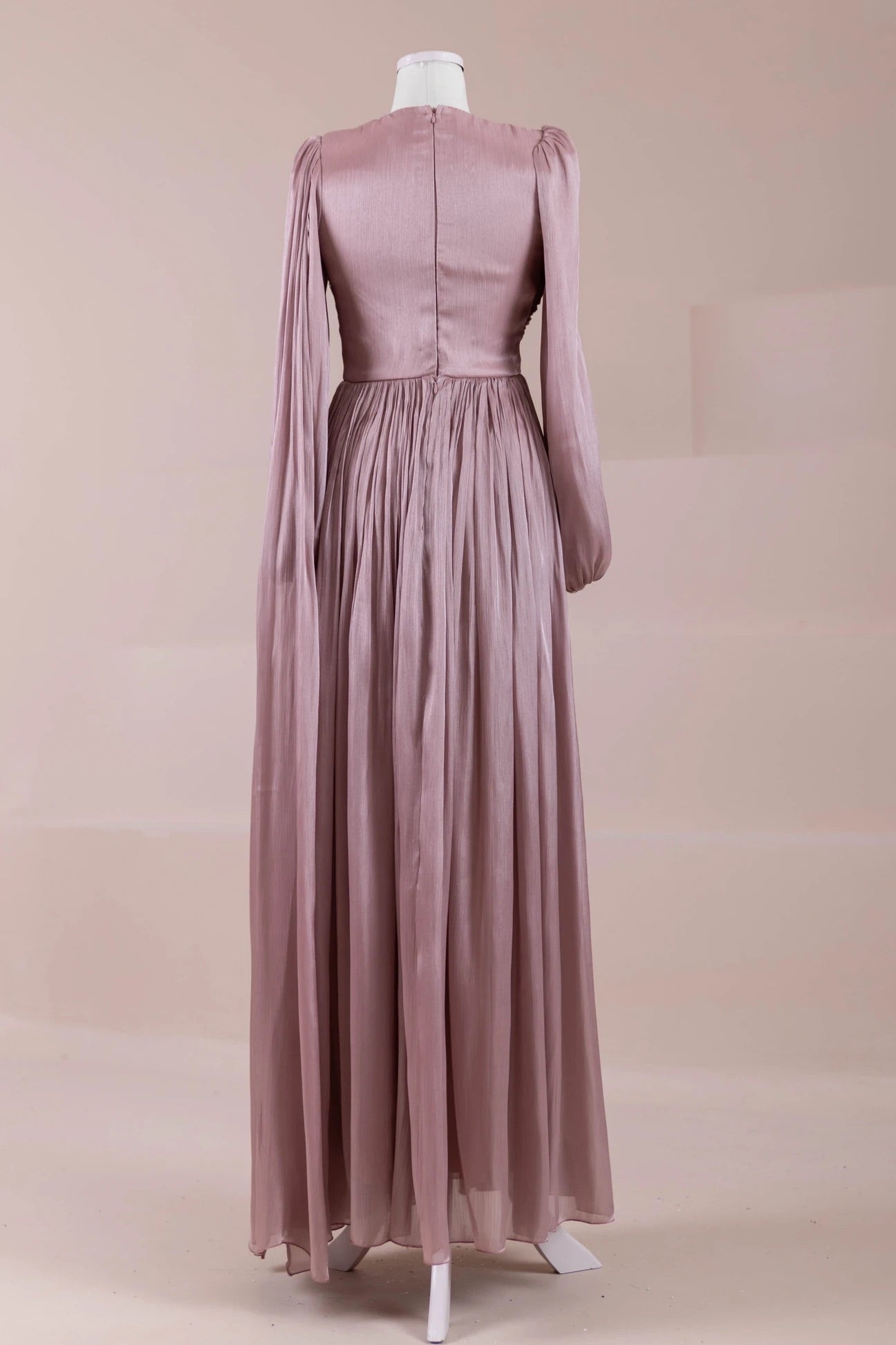 Back view of dusty rose pleated maxi dress with long sleeves and crystal waistband accents