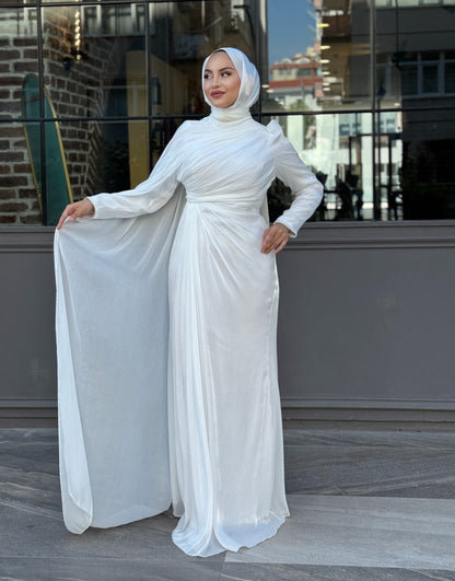 Graceful white formal gown featuring diagonal pleats, floor-length flow, and a matching hijab — ideal for engagement or reception events
