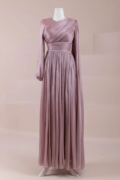 Front view of dusty rose pleated maxi dress with long sleeves and crystal waistband accents