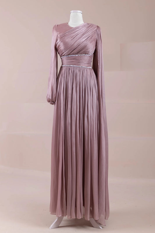 Front view of dusty rose pleated maxi dress with long sleeves and crystal waistband accents