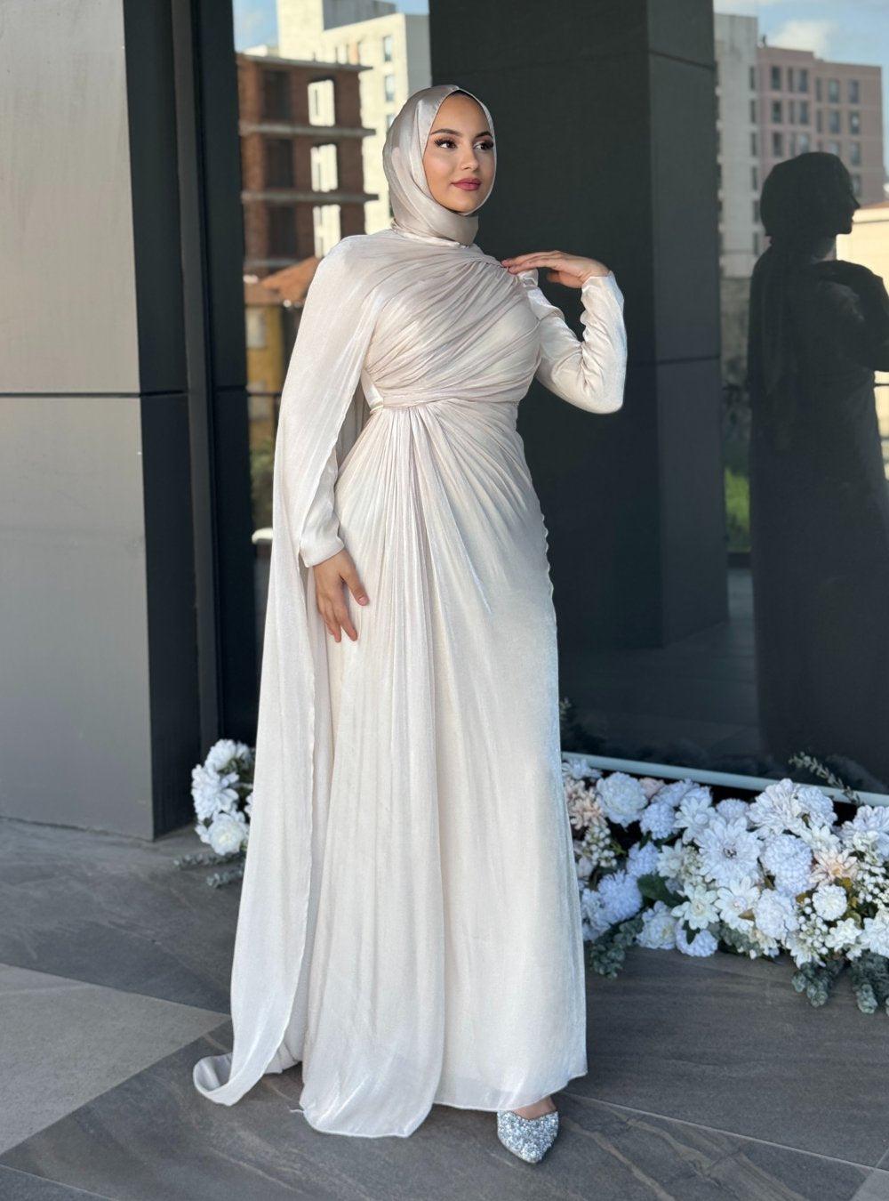 Graceful champagne formal gown featuring diagonal pleats, floor-length flow, and a matching hijab — ideal for engagement or reception events